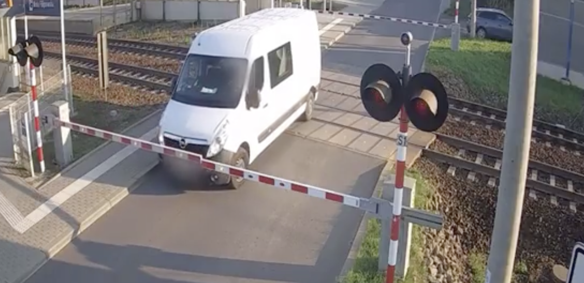 Van driver runs the red light and gets hit by a train