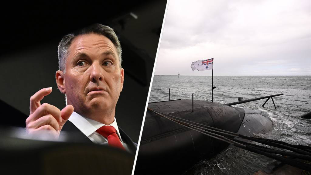 Split image: man in suit and red tie speaking on the left, submarine with Australian flag on the right.
