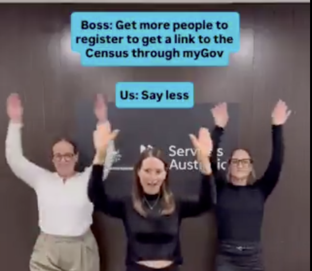 Three coworkers raise their hands in celebration as blue chat bubbles read: Boss—'Get more people to register to get a link to the Census through myGov' and Us—'Say less'.