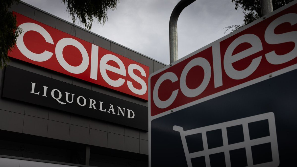 Storefront signage showing 'Coles' in red with a 'LIQUORLAND' sign beneath; a shopping cart icon is visible on a dark panel in the foreground.